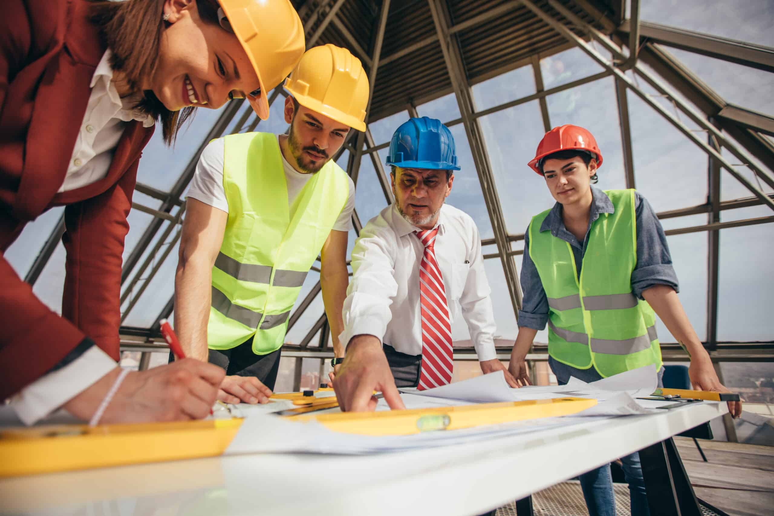 Construction professionals having a meeting over plans