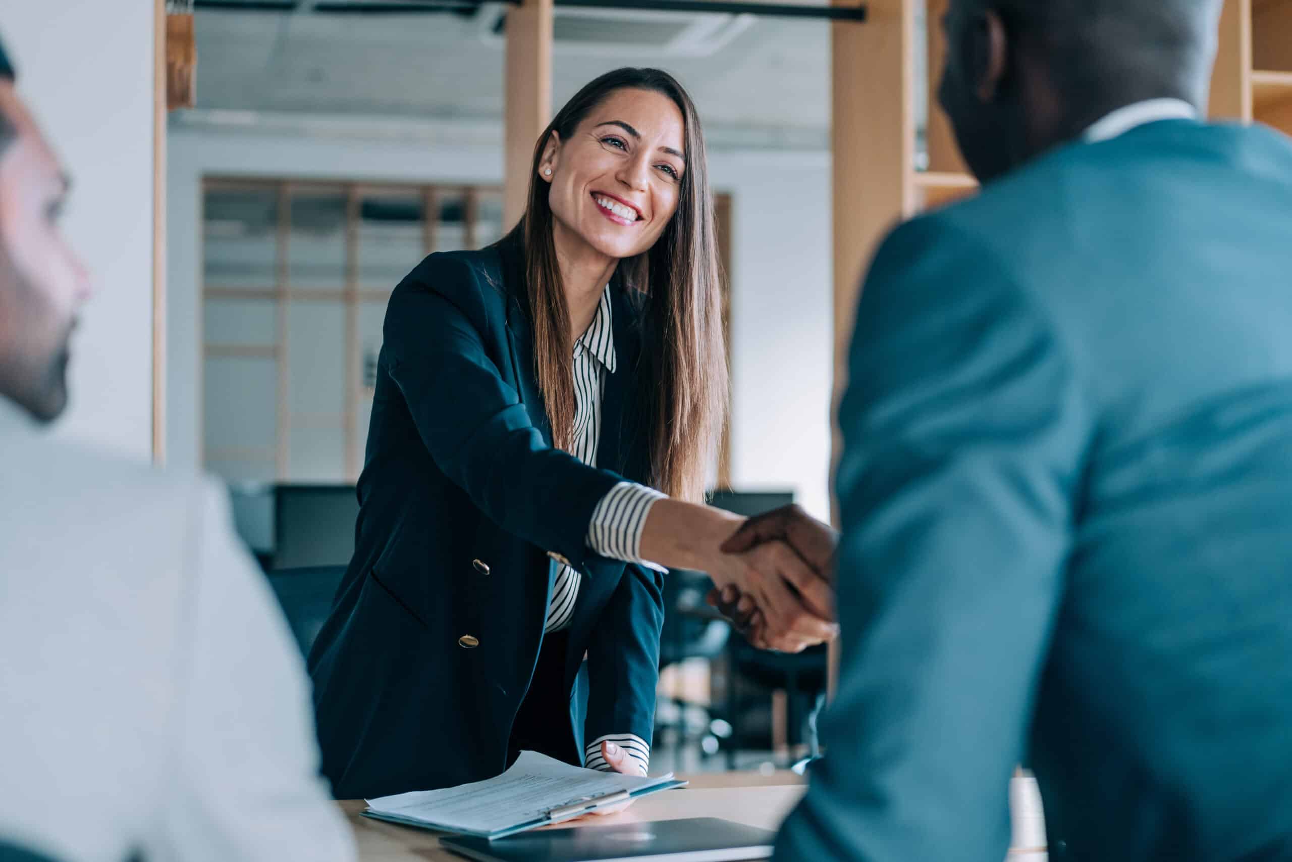 Sales professionals closing a deal and shaking hands